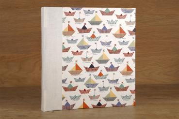 Album with white pages, paper boats, handmade